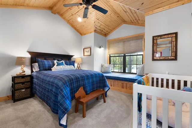 a spacious bedroom with a bed and a large window