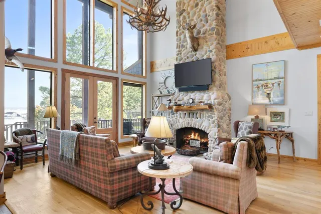 a living room with furniture fireplace and a large window