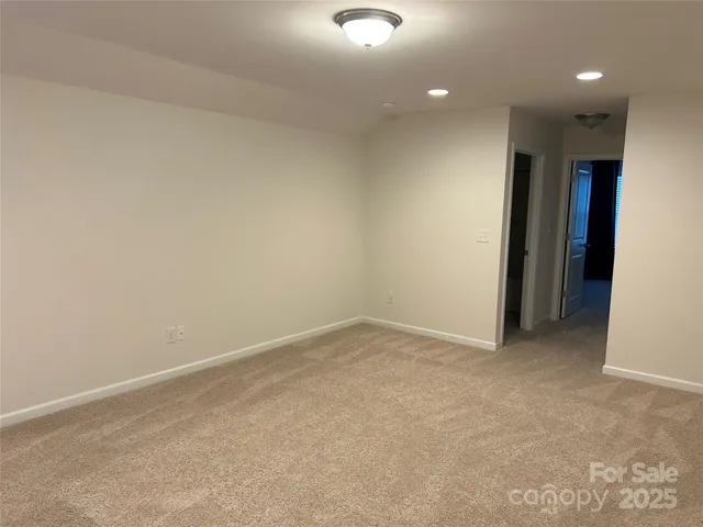 en empty room with windows and ceiling fan
