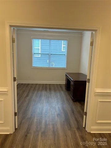 a view of wooden floor and windows in a room