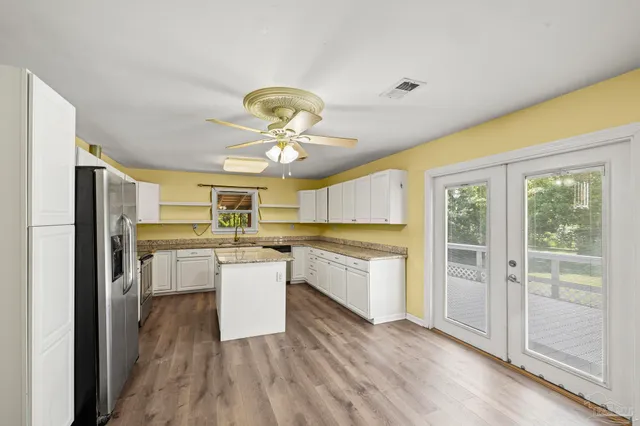 a kitchen with a refrigerator and microwave