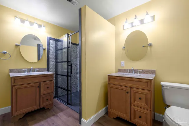 a bathroom with a toilet a sink and mirror