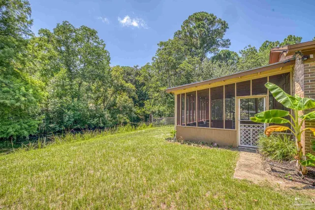 a view of house with backyard and garden