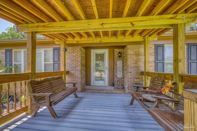 a view of a porch with wooden floor and iron stairs