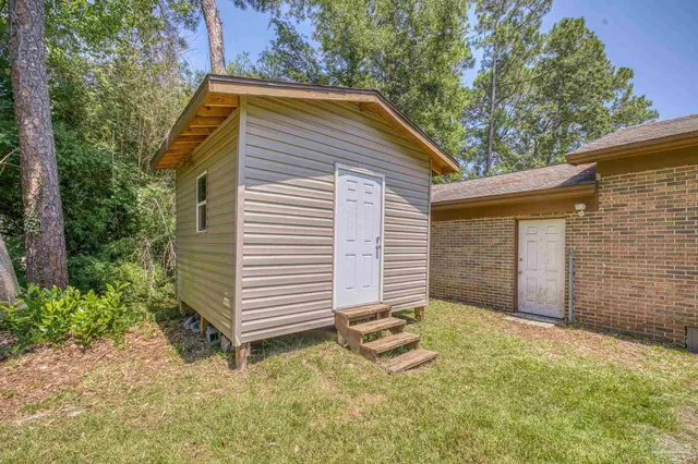 a view of a house with a yard and garage