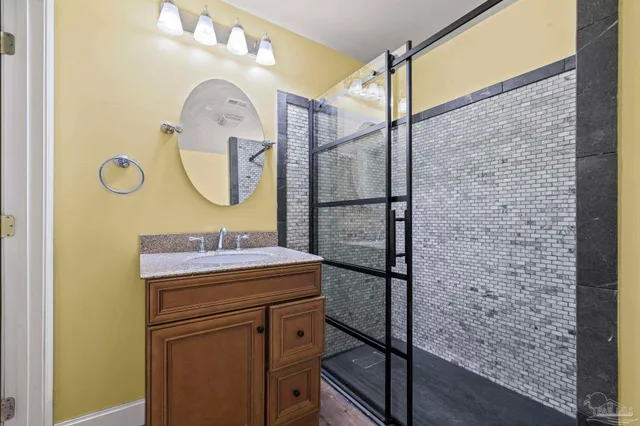 a bathroom with a sink mirror and vanity