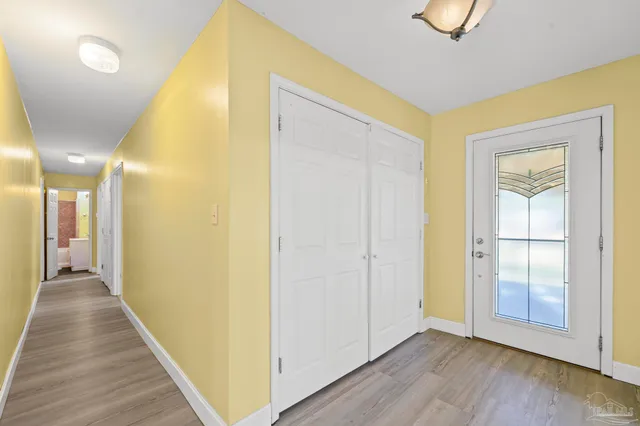 a view of a hallway with wooden floor