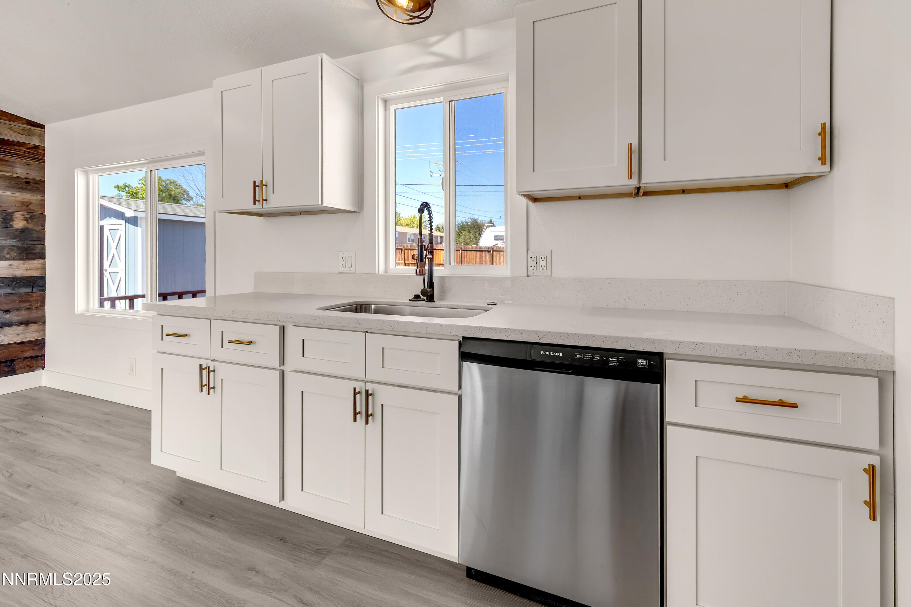 145 Wewoka Way Sun Valley, NV 89433 - Photo 11 of 36 a kitchen with stainless steel appliances granite countertop a sink stove and cabinets