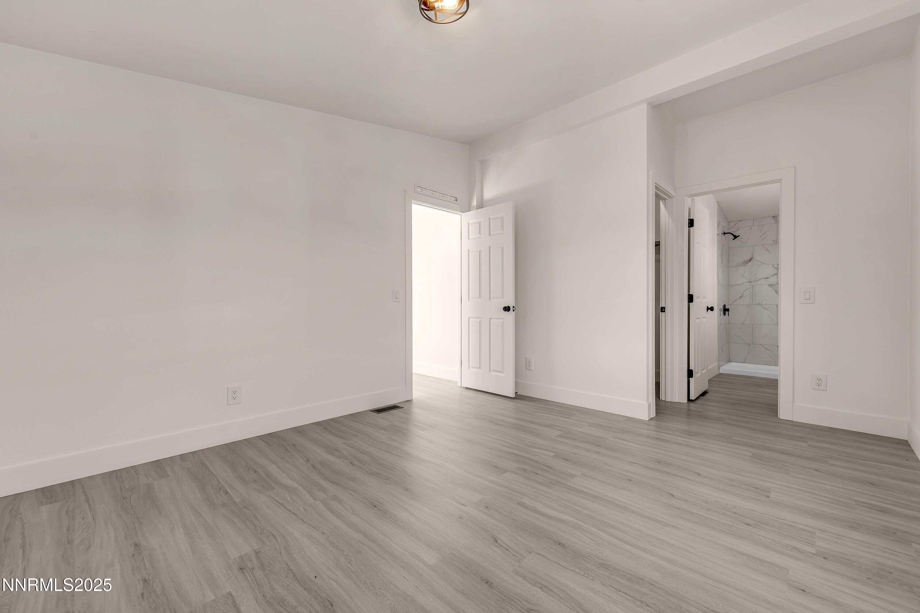 145 Wewoka Way Sun Valley, NV 89433 - Photo 13 of 36 a view of an empty room with wooden floor and closet