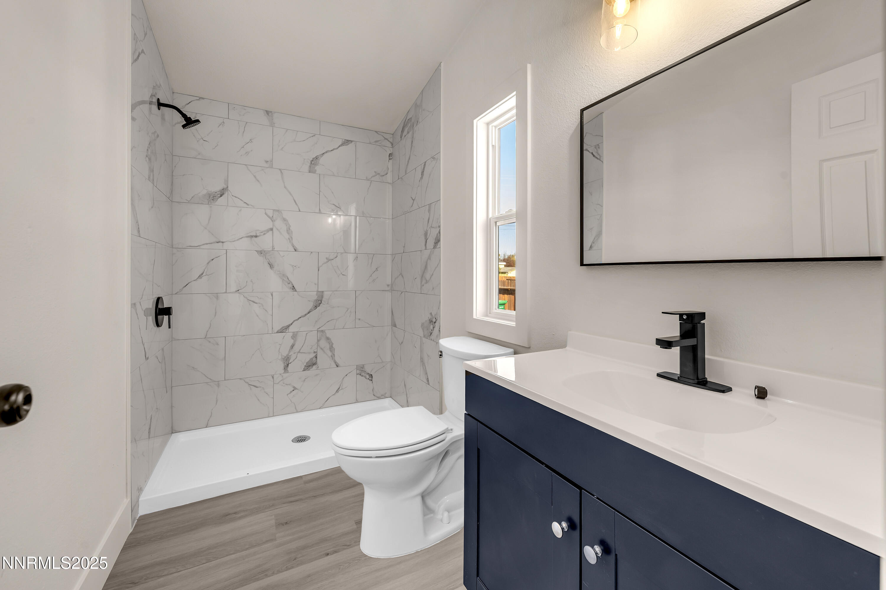 145 Wewoka Way Sun Valley, NV 89433 - Photo 15 of 36 a bathroom with a sink a toilet and shower