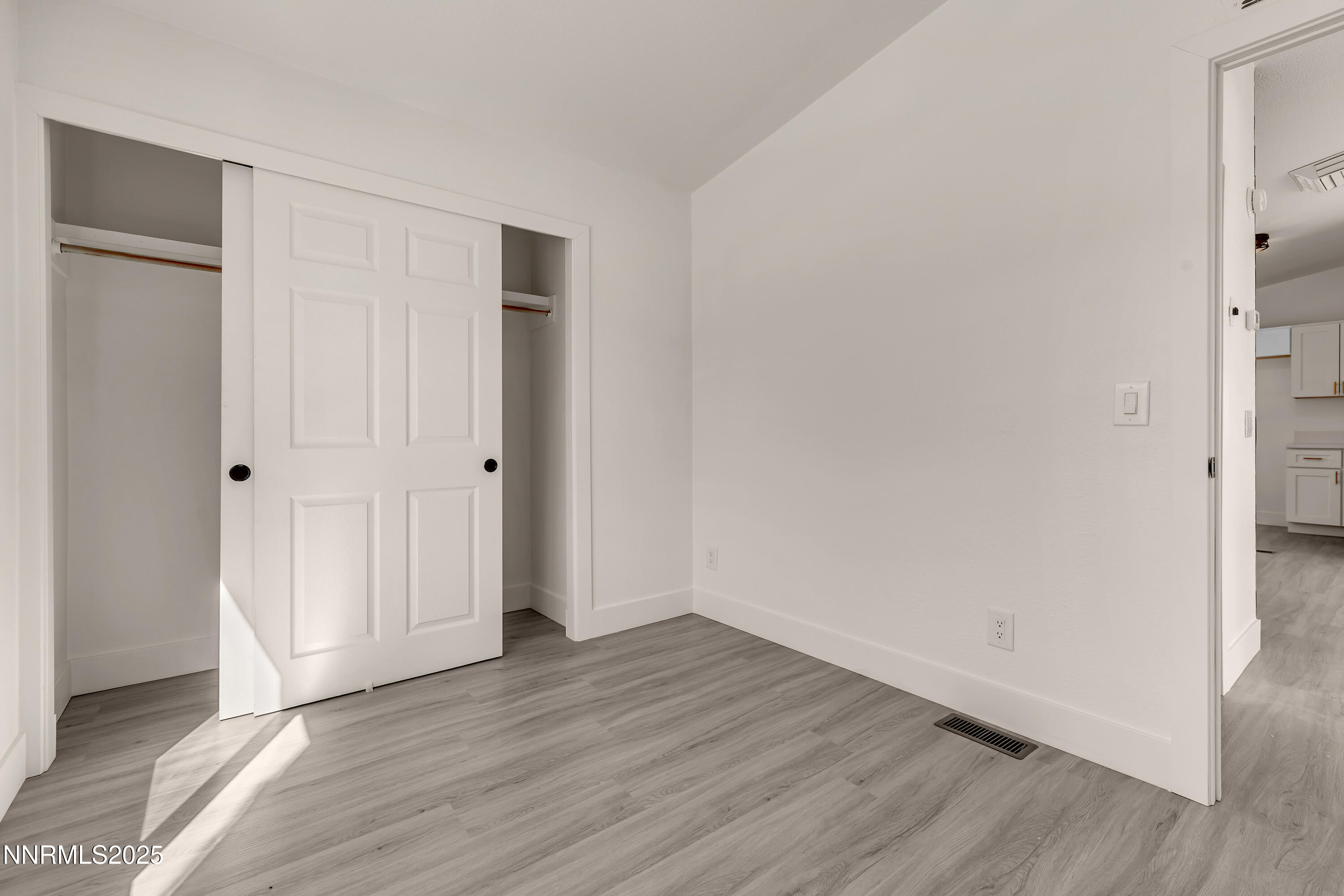 145 Wewoka Way Sun Valley, NV 89433 - Photo 19 of 36 a view of an empty room with wooden floor
