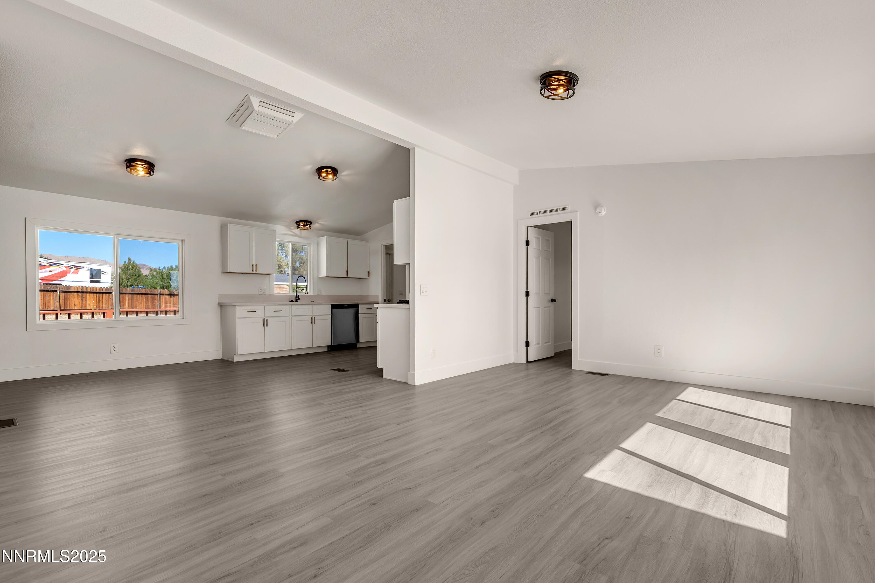 145 Wewoka Way Sun Valley, NV 89433 - Photo 2 of 36 a view of a kitchen with furniture and wooden floor