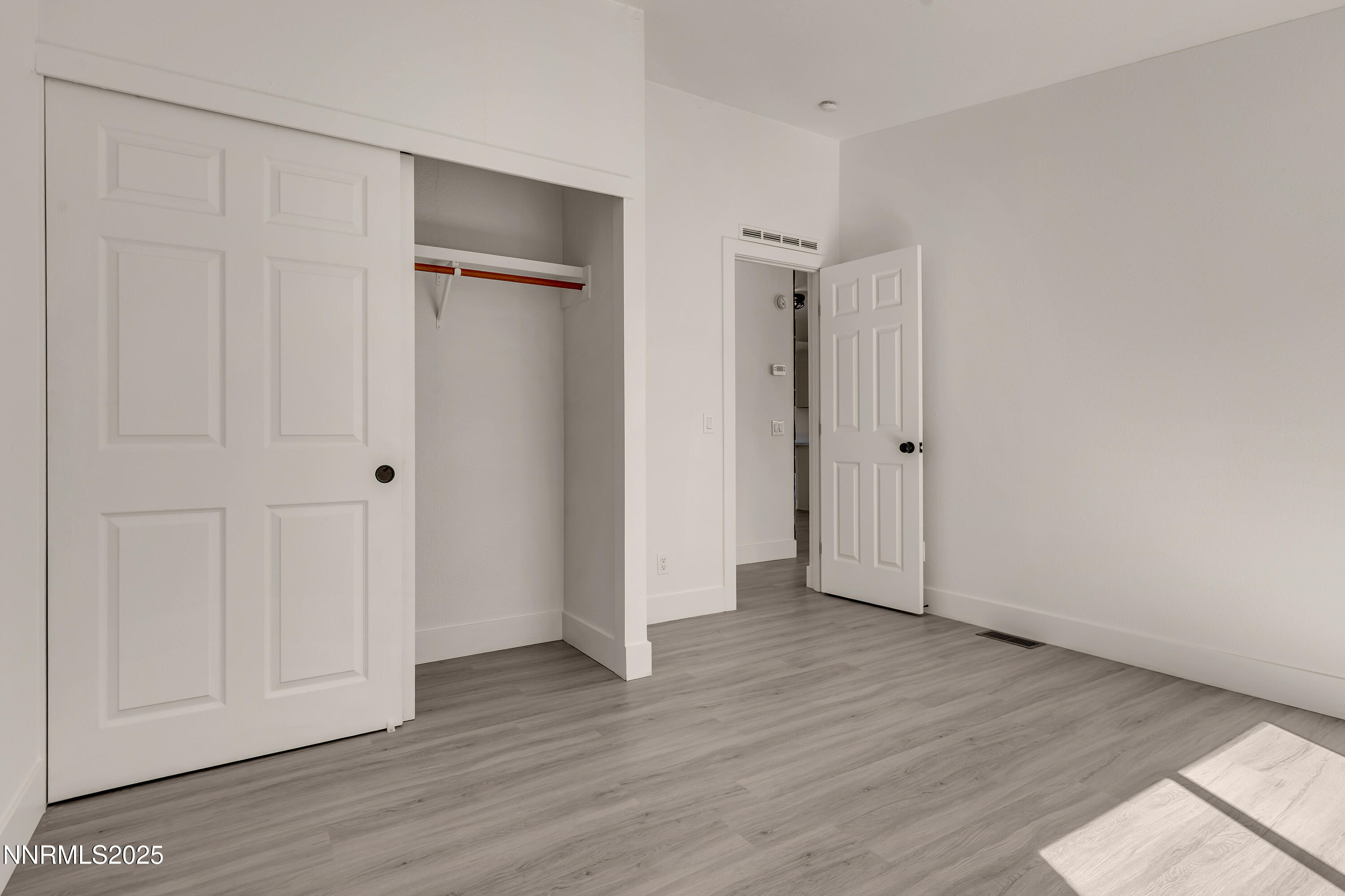 145 Wewoka Way Sun Valley, NV 89433 - Photo 21 of 36 a view of an empty room with wooden floor