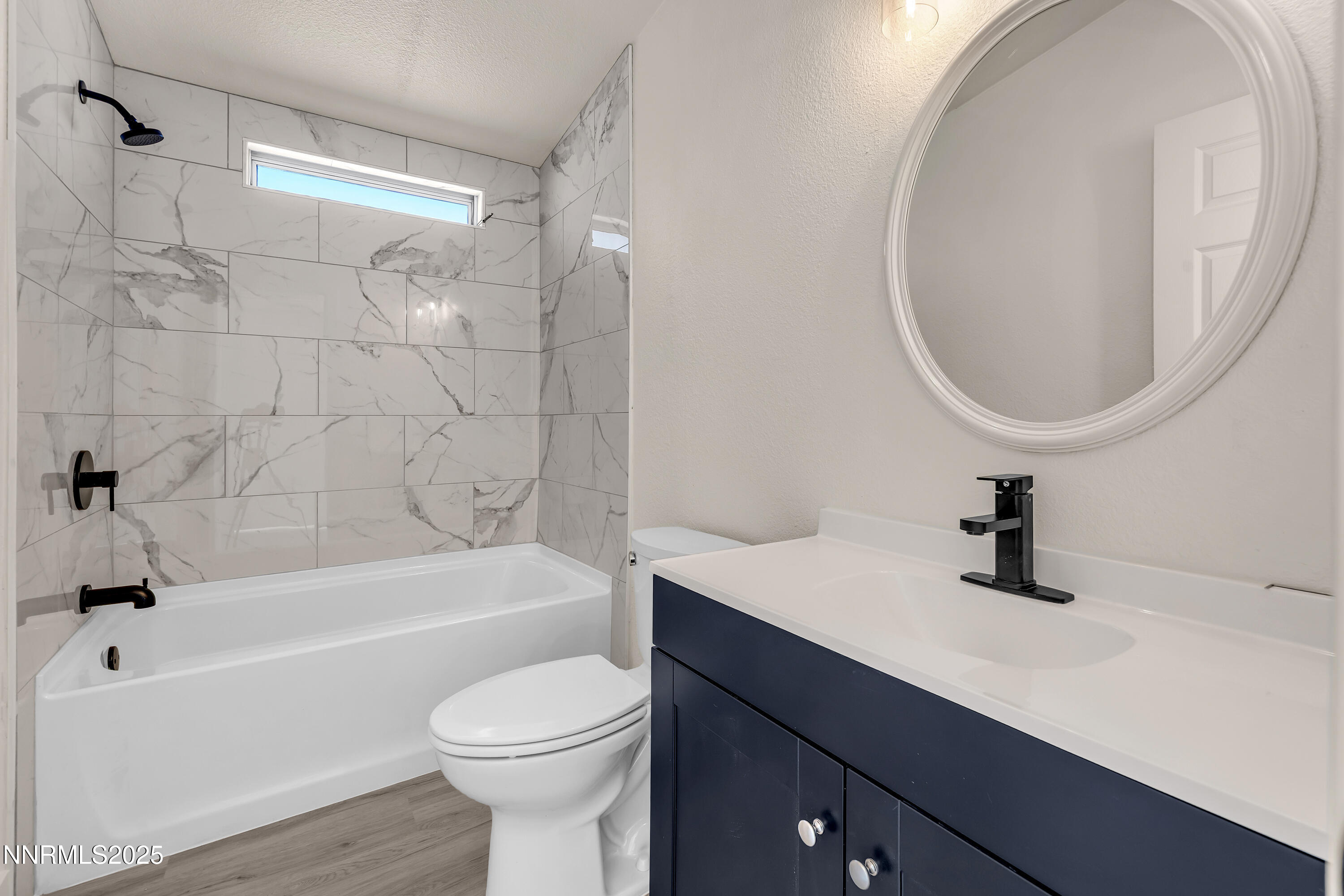 145 Wewoka Way Sun Valley, NV 89433 - Photo 22 of 36 a bathroom with a sink a toilet and a bathtub