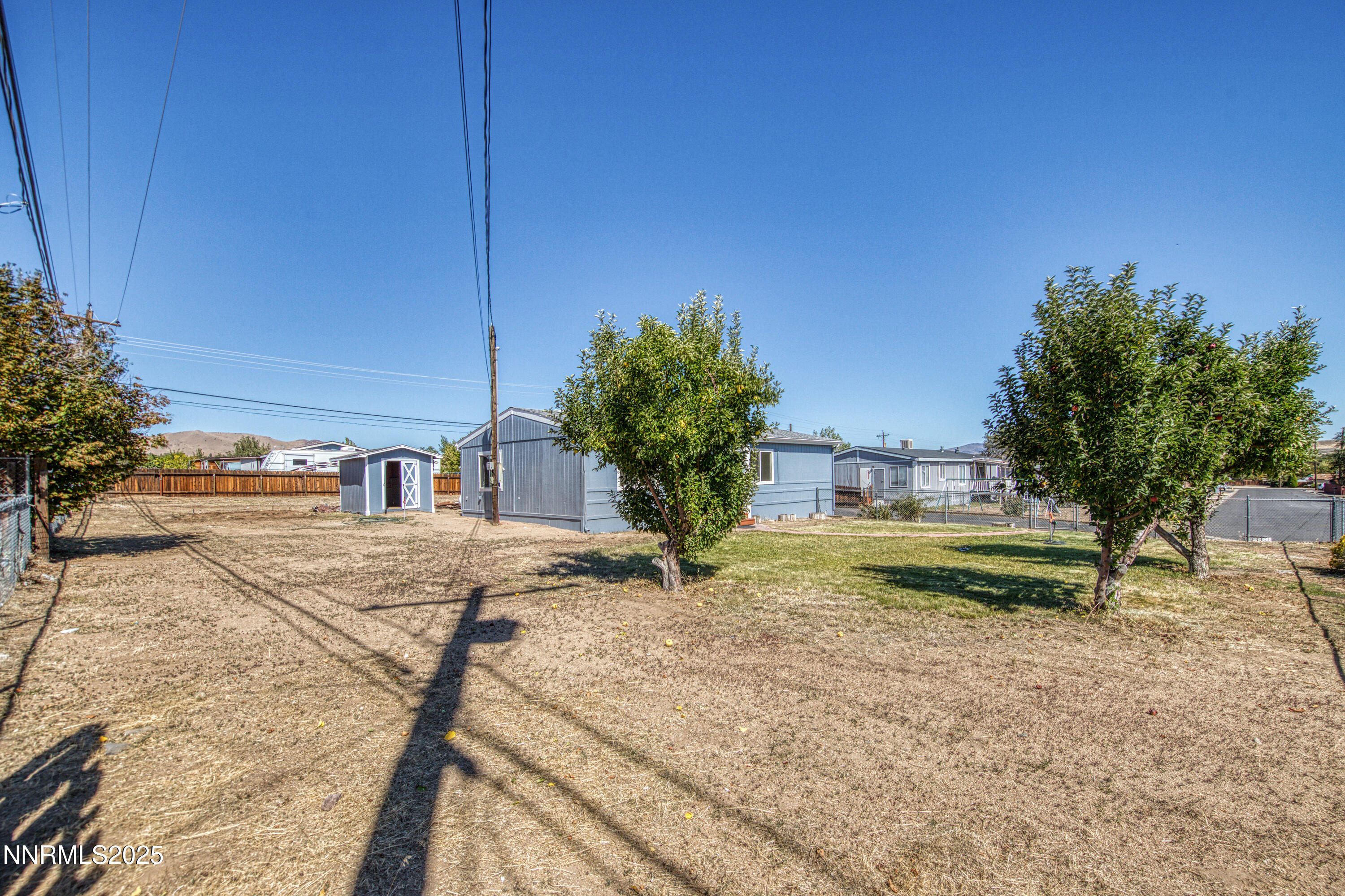 145 Wewoka Way Sun Valley, NV 89433 - Photo 25 of 36 a view of a house with a yard