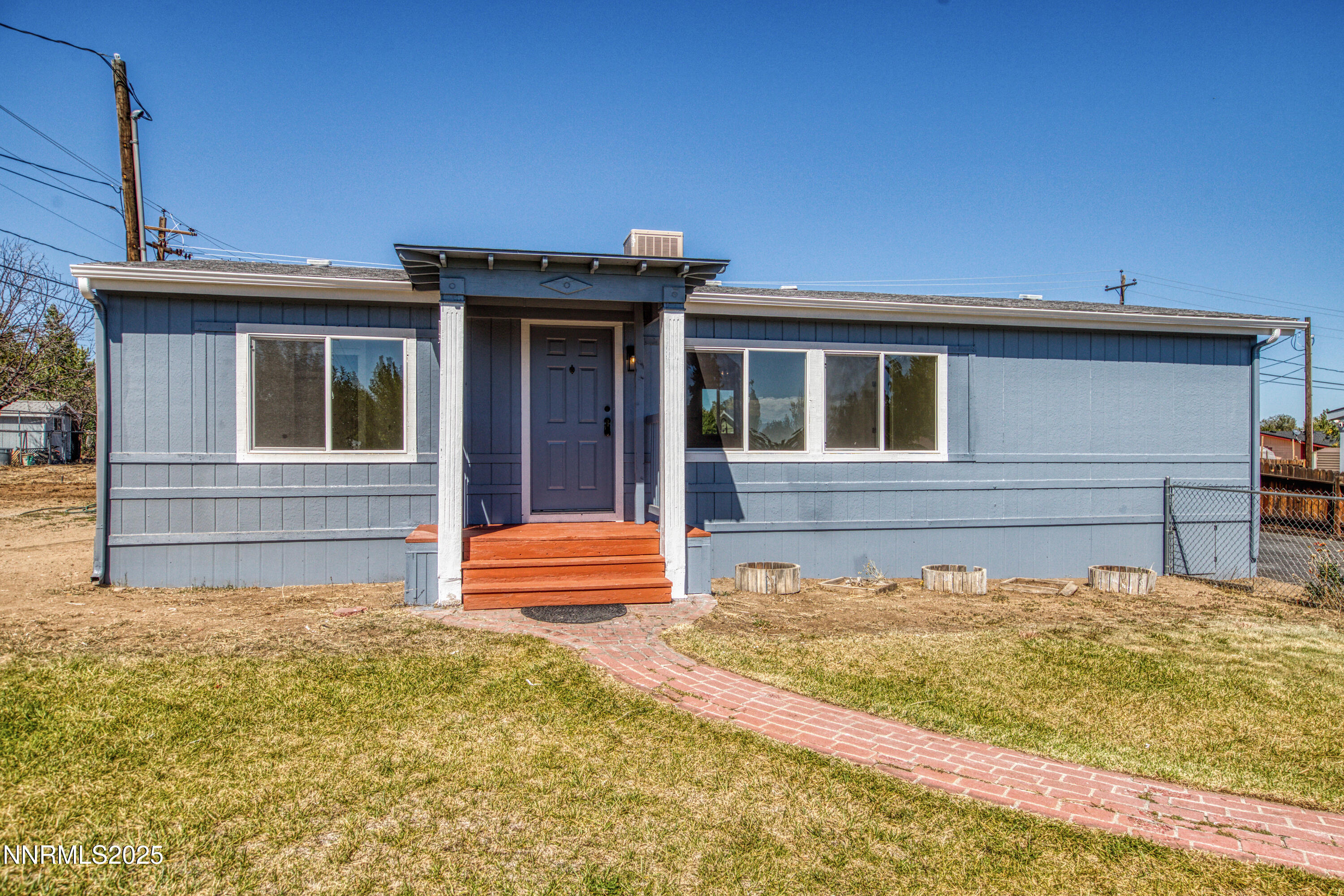 145 Wewoka Way Sun Valley, NV 89433 - Photo 32 of 36 a front view of a house with a yard
