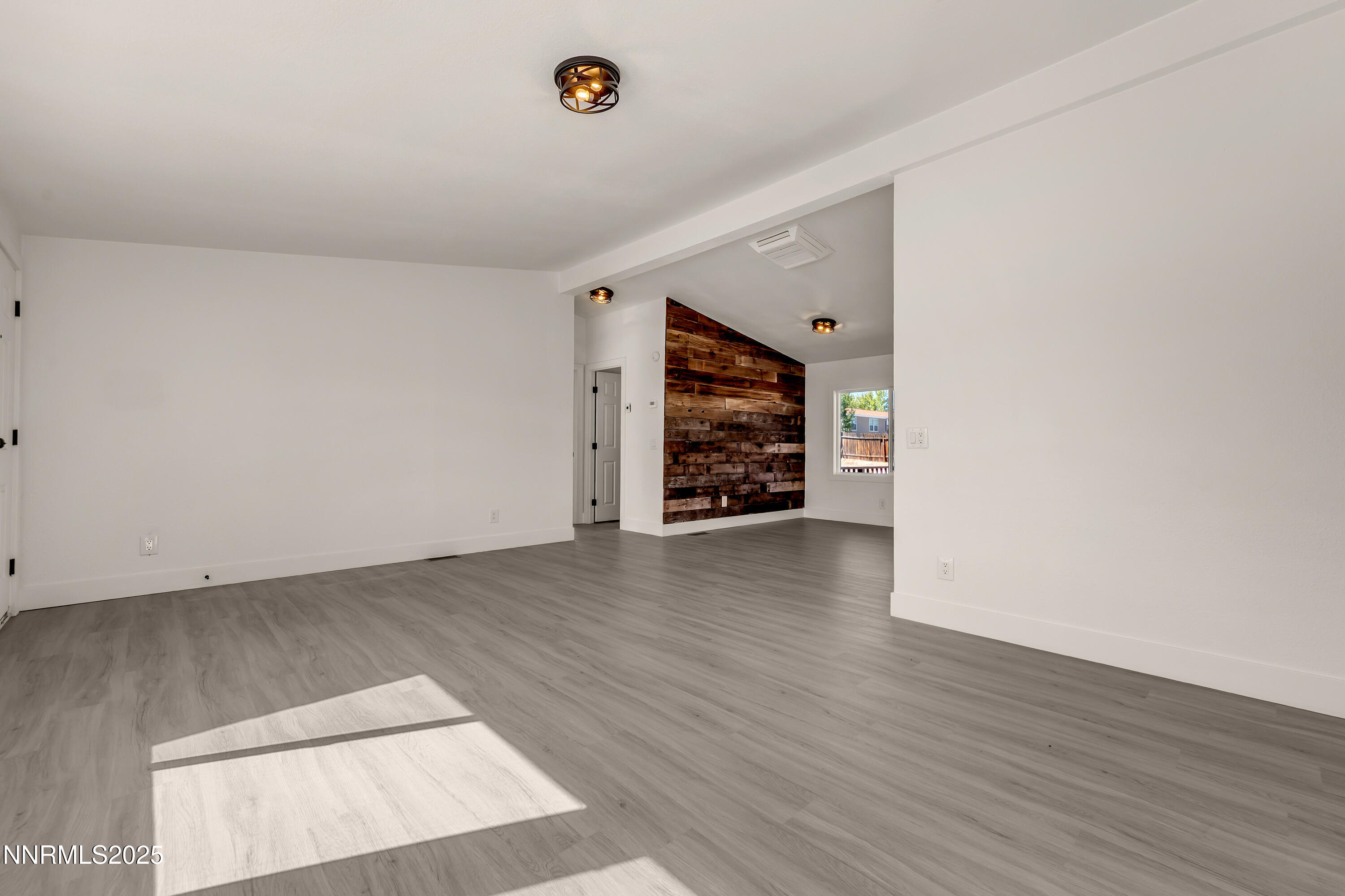 145 Wewoka Way Sun Valley, NV 89433 - Photo 5 of 36 an empty room with wooden floor