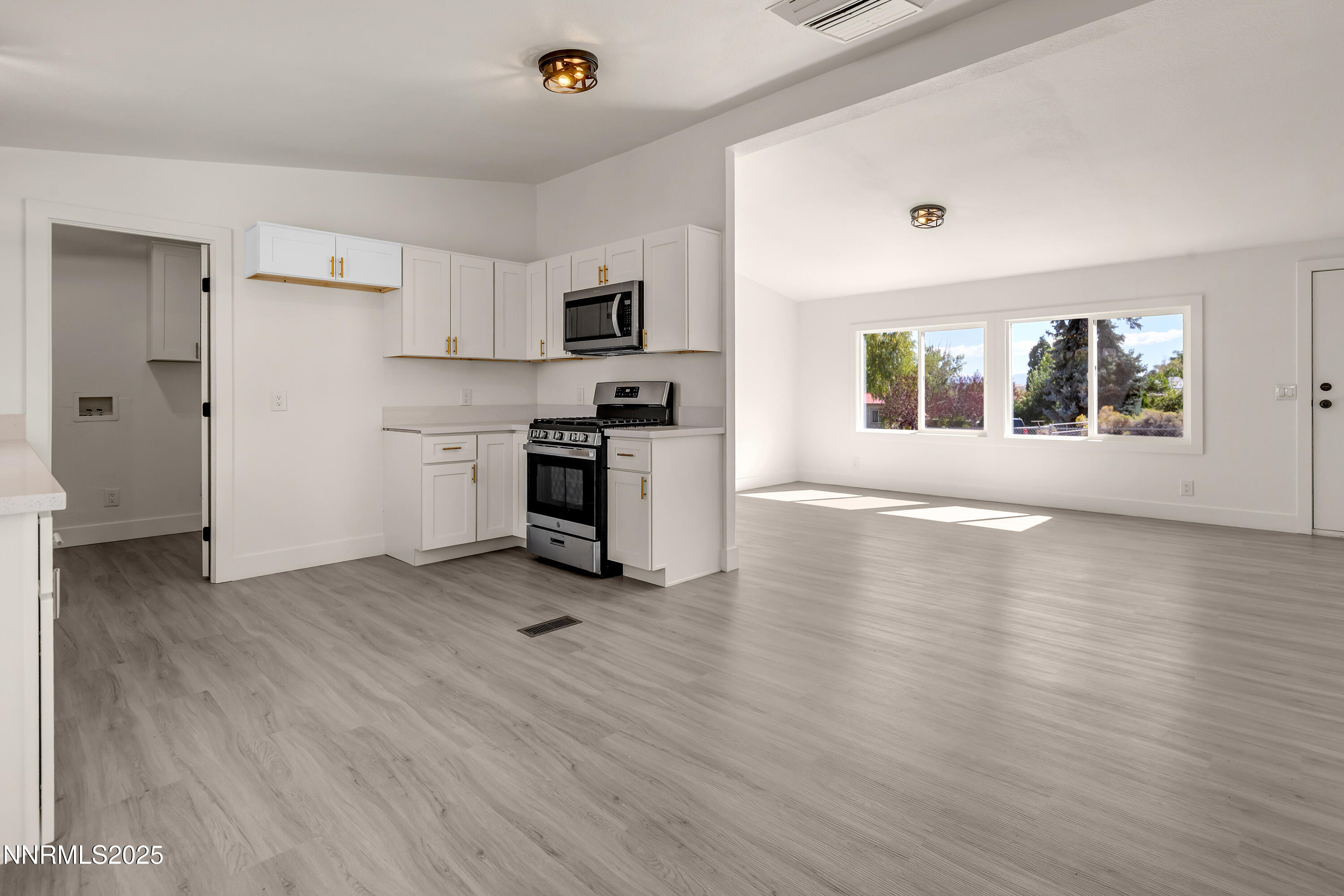 145 Wewoka Way Sun Valley, NV 89433 - Photo 9 of 36 a view of kitchen with stove and refrigerator
