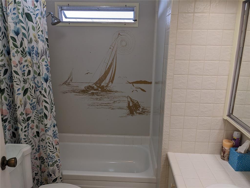 800 32nd Avenue South, Unit 612 St. Petersburg, FL 33705 - Photo 11 of 16 a bathroom with a bathtub