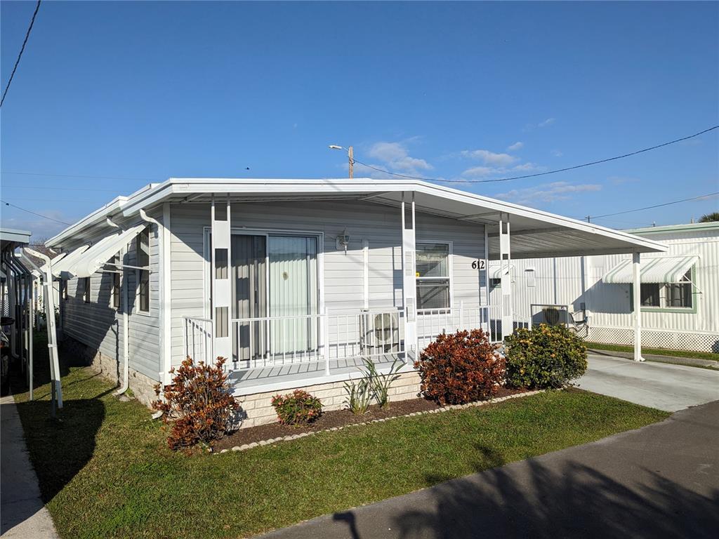 800 32nd Avenue South, Unit 612 St. Petersburg, FL 33705 - Photo 2 of 16 a front view of a house with a yard