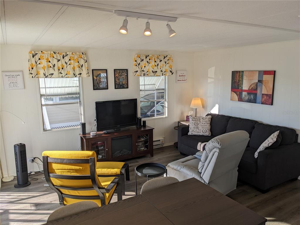800 32nd Avenue South, Unit 612 St. Petersburg, FL 33705 - Photo 5 of 16 a living room with furniture and a flat screen tv