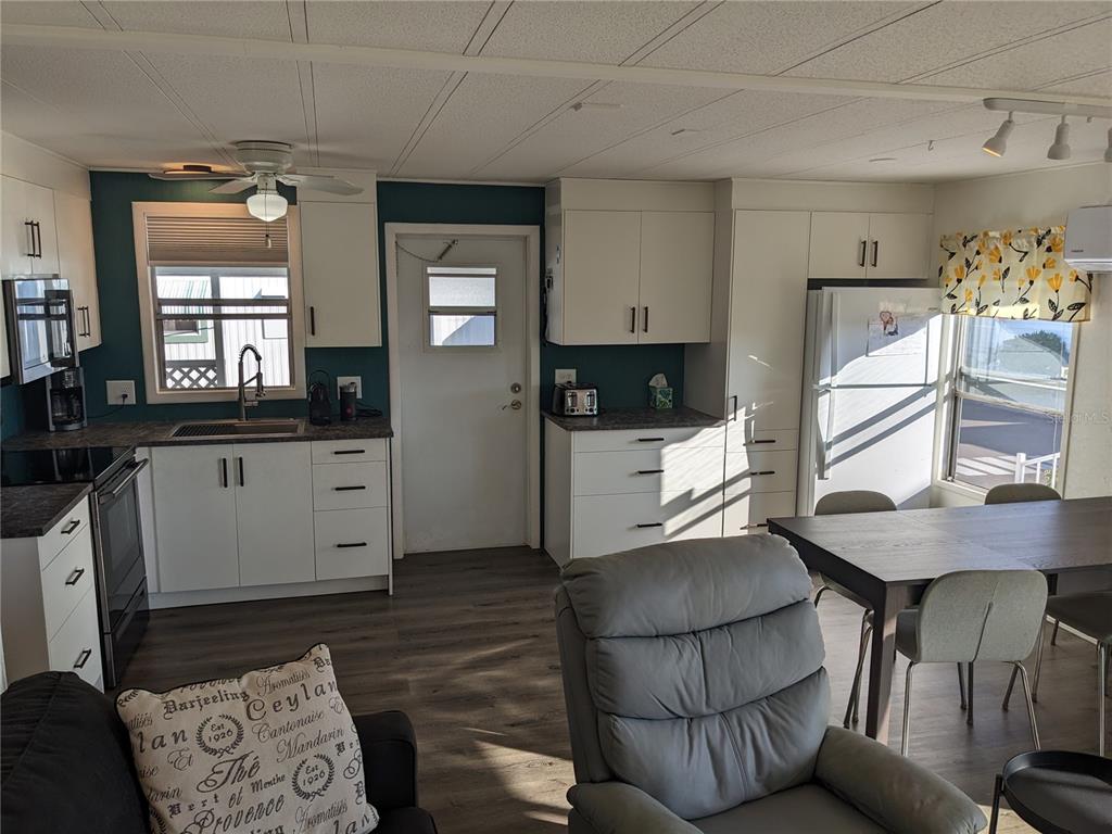 800 32nd Avenue South, Unit 612 St. Petersburg, FL 33705 - Photo 6 of 16 a kitchen with stainless steel appliances kitchen island granite countertop a stove a sink and a refrigerator