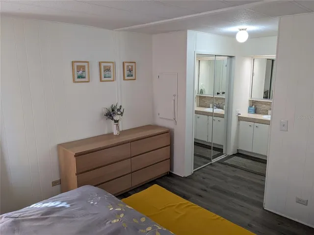 a room with a bed and cabinets