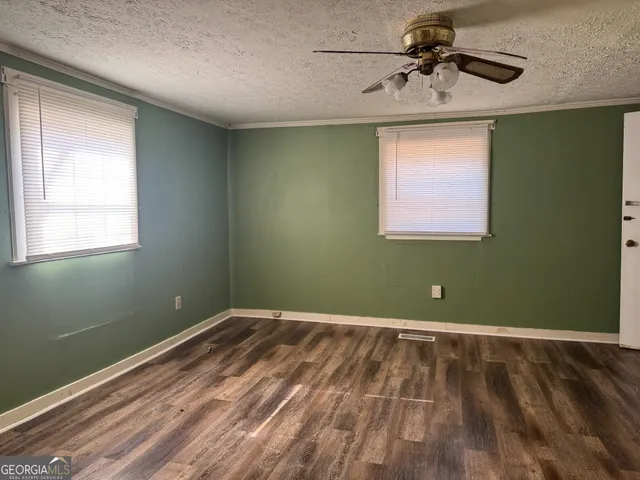a view of room with window and ceiling fan