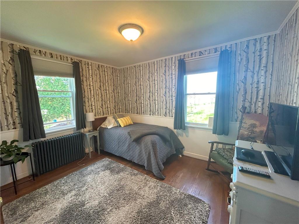 1920 Ridge Rd Extension Ambridge, PA 15003 - Photo 16 of 40 a bed sitting in a bedroom next to a window