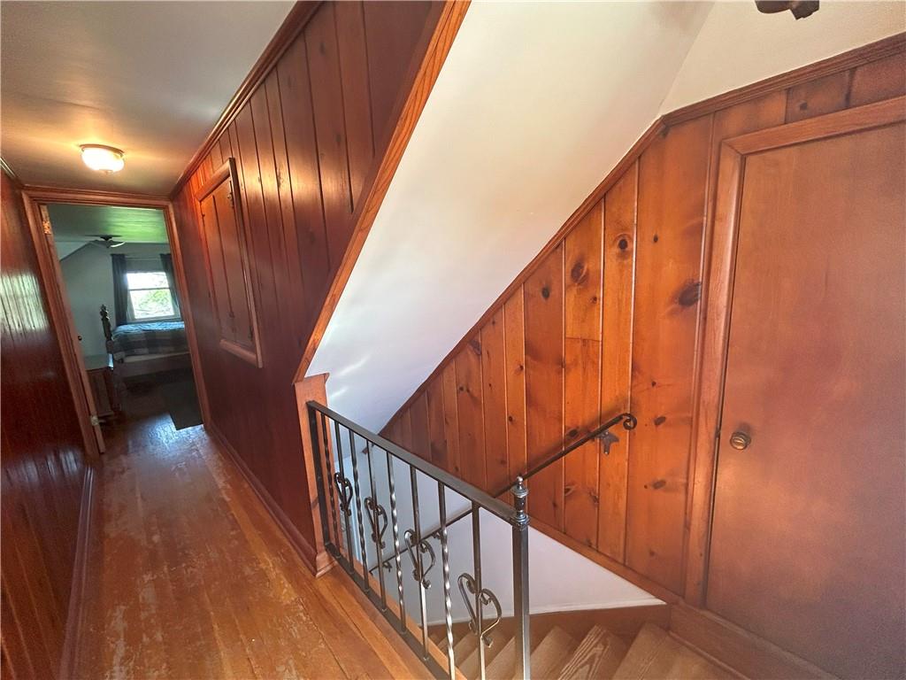 1920 Ridge Rd Extension Ambridge, PA 15003 - Photo 22 of 40 a view of staircase with lots of frames on wall and wooden floor