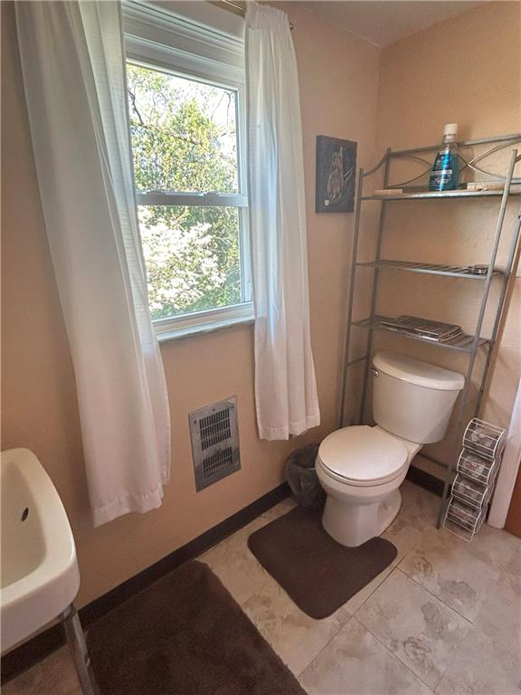 1920 Ridge Rd Extension Ambridge, PA 15003 - Photo 26 of 40 a bathroom with a toilet and a sink