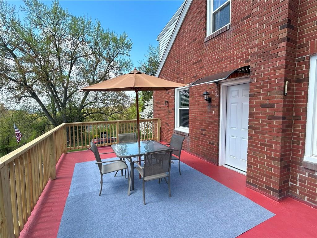 1920 Ridge Rd Extension Ambridge, PA 15003 - Photo 34 of 40 a roof deck with a table and chairs under an umbrella