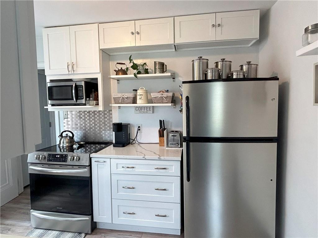 1920 Ridge Rd Extension Ambridge, PA 15003 - Photo 7 of 40 a kitchen with stainless steel appliances a refrigerator sink and cabinets