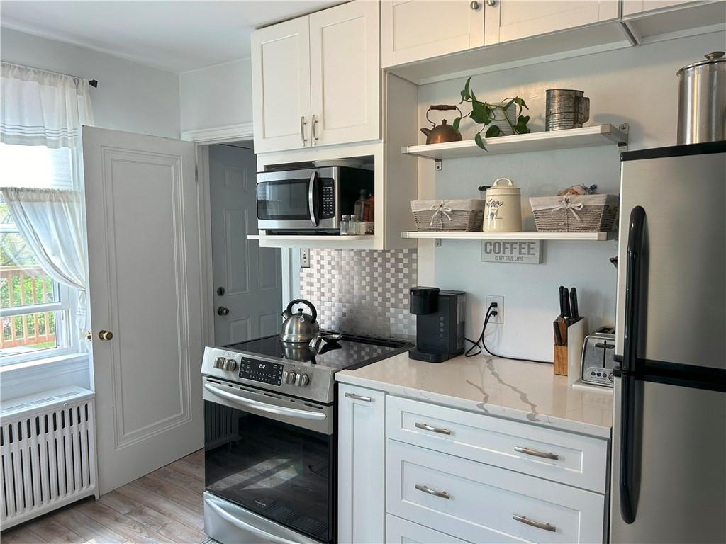 1920 Ridge Rd Extension Ambridge, PA 15003 - Photo 8 of 40 a kitchen with stainless steel appliances white cabinets and a refrigerator