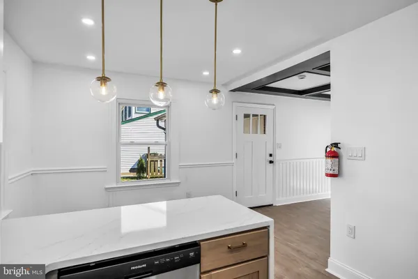 a kitchen with a refrigerator and a stove top oven