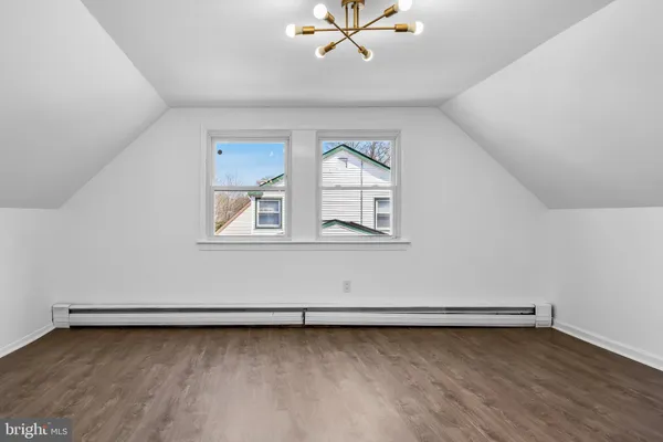 a view of a room with wooden floor and window