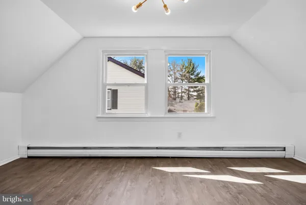 a view of a big room with wooden floor and large window