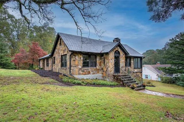 a front view of house with yard porch and green space