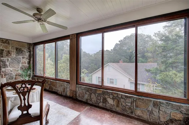 a living room with large window and a wooden floor