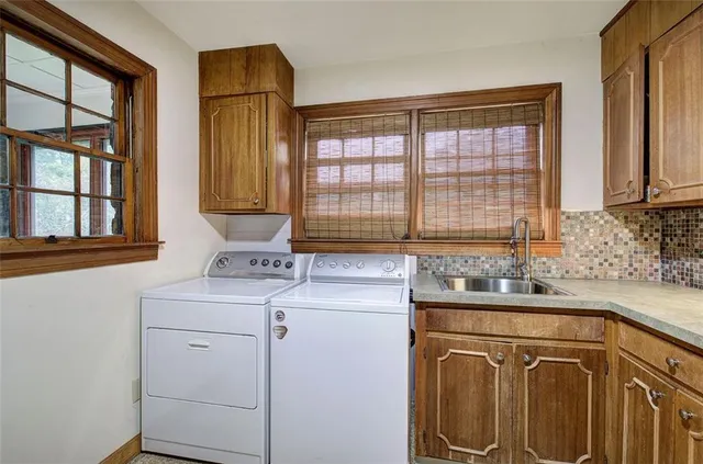 a living room with furniture and floor to ceiling windows