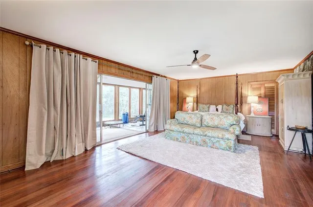 a view of a livingroom with furniture and floor to ceiling window