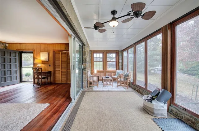 a view of a hallway with wooden floor and closet