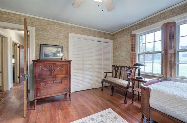 a view of a hallway with wooden floor and couch