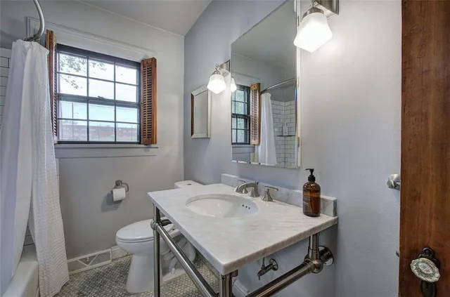 a view of a livingroom with wooden floor and furniture