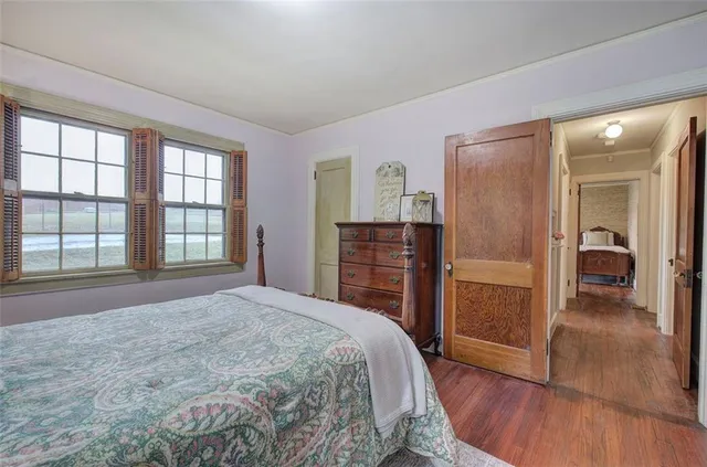 a bedroom with a bed and a mirror