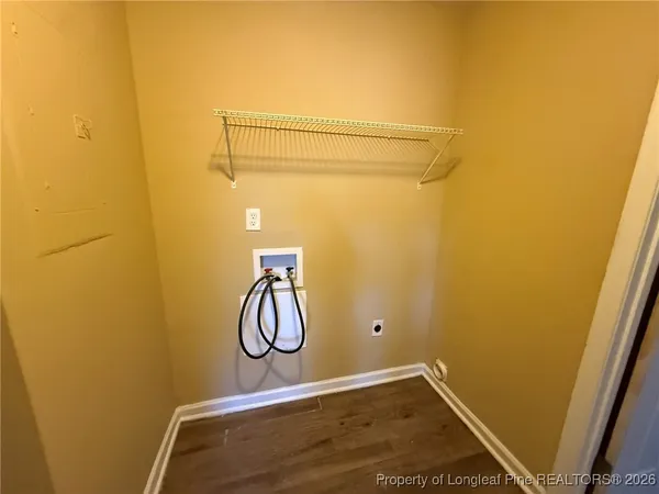 a room with a table and a chandelier