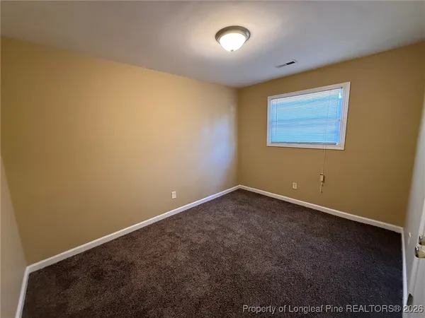 an empty room with a projector and a window