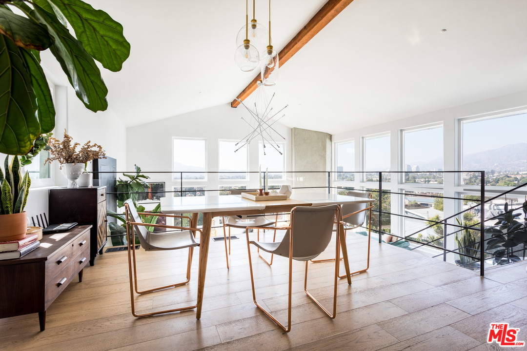 1320 Romulus Drive Glendale, CA 91205 - Photo 9 of 54 a kitchen with stainless steel appliances kitchen island granite countertop a table chairs in it and wooden floors