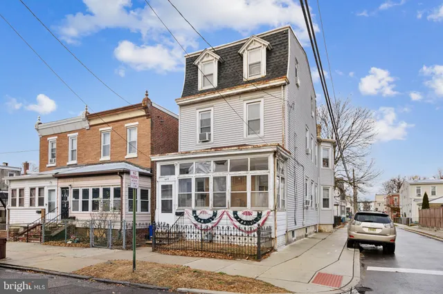 a front view of a building with parking space