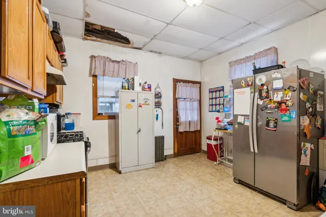 a view of storage and utility room with refrigerator and toys